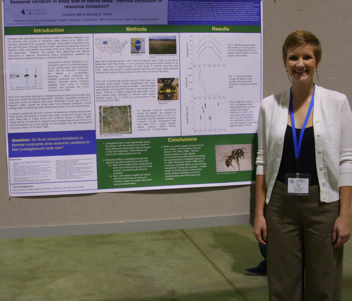 Christy Bell standing next to poster